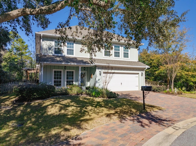 view of front of house with a front yard and a garage