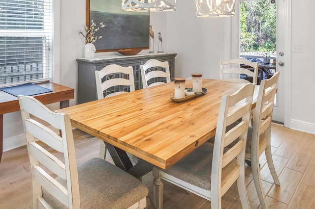 dining room featuring light wood-type flooring and a notable chandelier