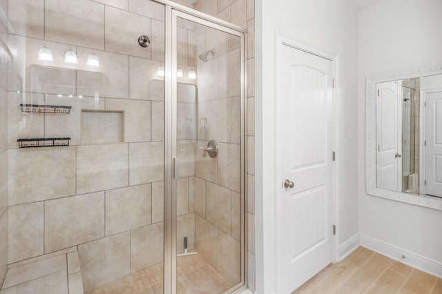 bathroom featuring a shower with shower door