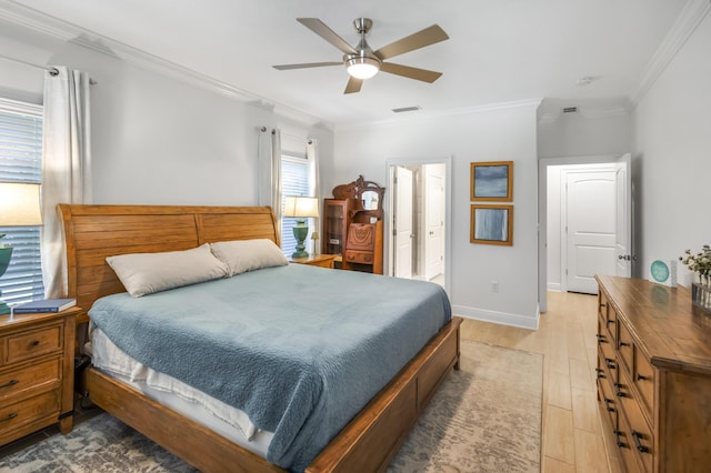 bedroom featuring light wood-type flooring, ceiling fan, connected bathroom, and crown molding