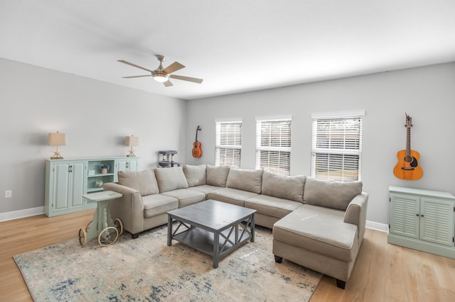 living room featuring light hardwood / wood-style flooring and ceiling fan