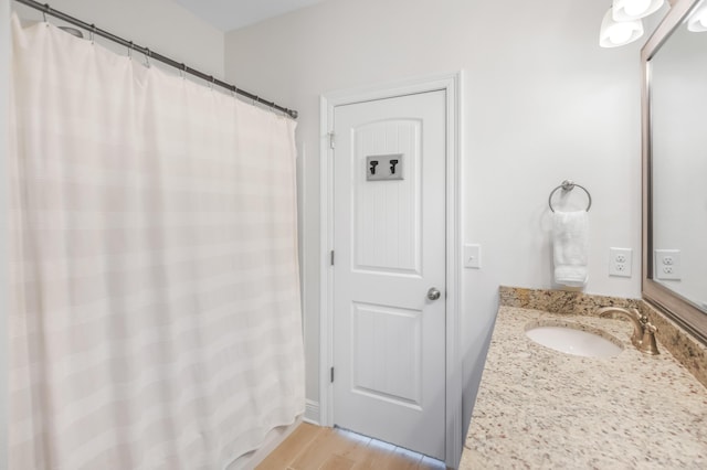 bathroom featuring wood-type flooring and vanity