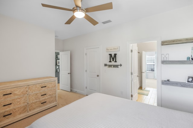 bedroom featuring ensuite bath and ceiling fan