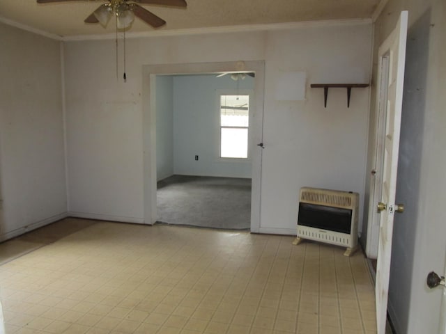 empty room with crown molding, heating unit, and ceiling fan