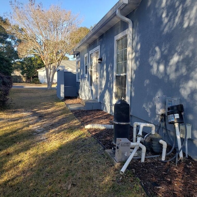 view of side of property with a yard