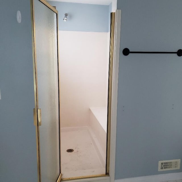 bathroom with a shower with door