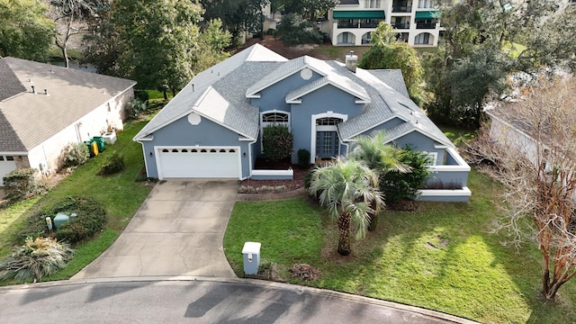 view of front of property with a garage and a front lawn