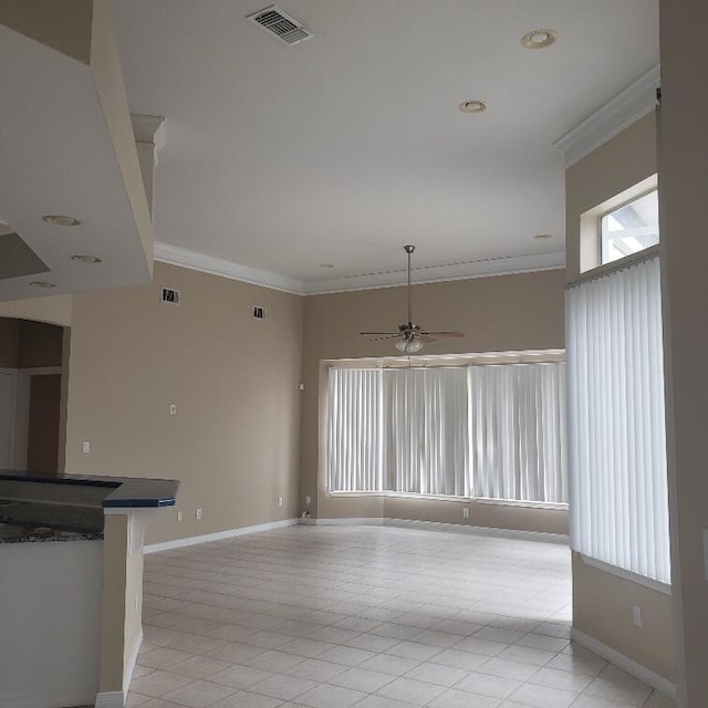 unfurnished living room featuring ceiling fan, ornamental molding, and light tile patterned floors