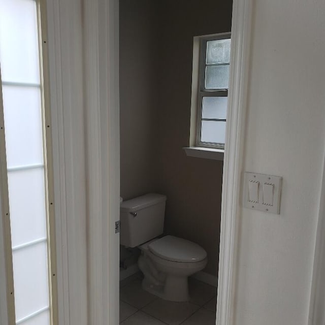 bathroom with tile patterned floors and toilet