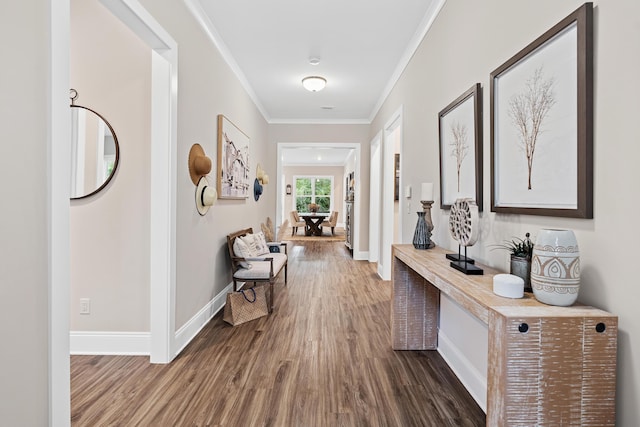 hall with hardwood / wood-style flooring and crown molding