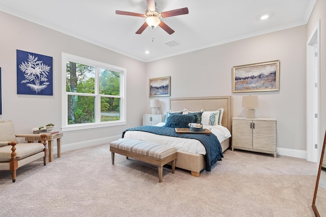 carpeted bedroom with ceiling fan and ornamental molding