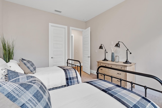 bedroom featuring light colored carpet