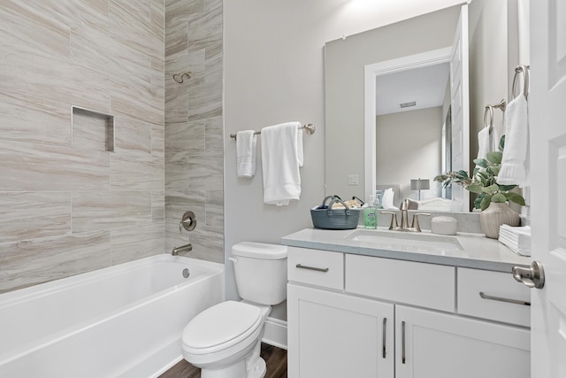 full bathroom with vanity, toilet, wood-type flooring, and tiled shower / bath combo