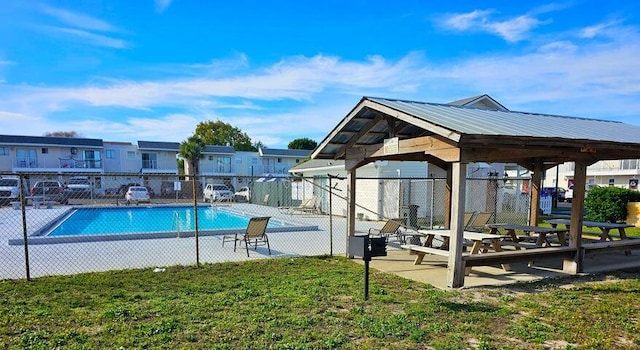 view of pool with a lawn, a patio area, and a gazebo