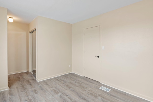 spare room with light wood-type flooring