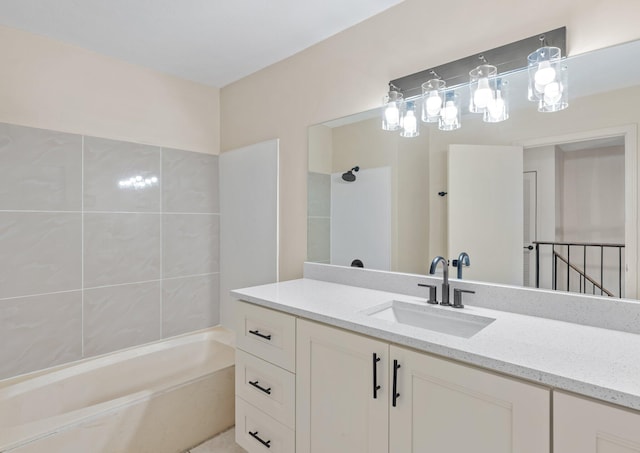 bathroom with vanity and tiled shower / bath