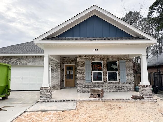 view of front facade featuring a garage and covered porch