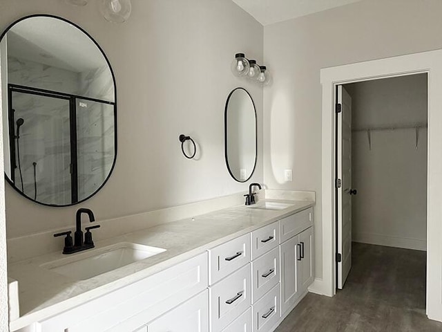 bathroom featuring vanity and an enclosed shower