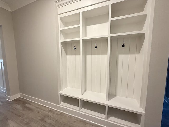 mudroom with wood finished floors and baseboards