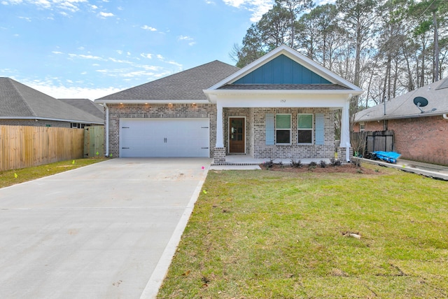 view of front facade featuring a garage, brick siding, concrete driveway, board and batten siding, and a front yard