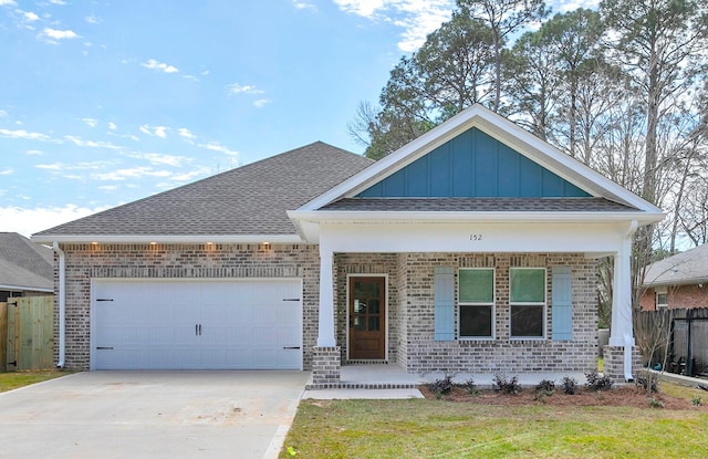 152 Harding Rd, Niceville, FL 32578 - view of front facade with brick siding, covered porch, board and batten siding, an attached garage, and driveway