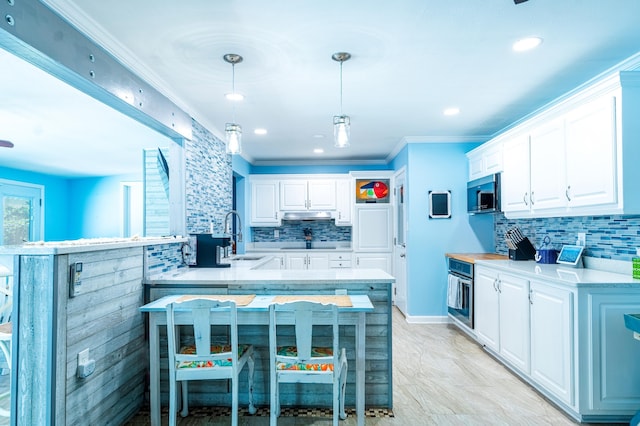 kitchen featuring white cabinetry, tasteful backsplash, decorative light fixtures, appliances with stainless steel finishes, and kitchen peninsula