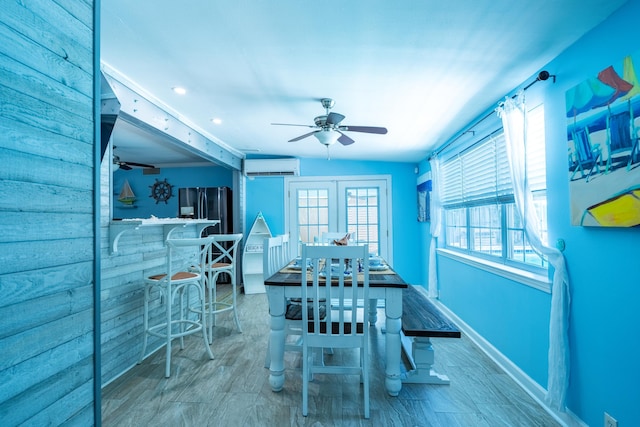 unfurnished dining area with ceiling fan, hardwood / wood-style floors, french doors, and a wall mounted AC