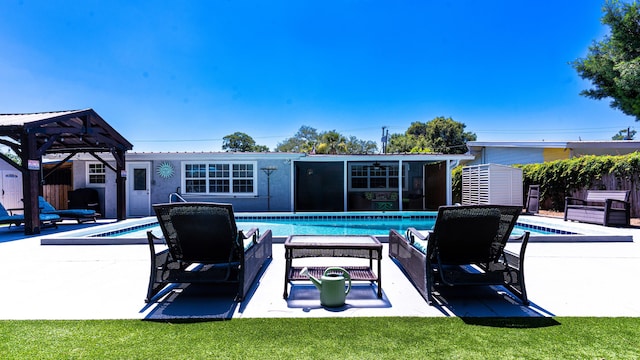 view of pool with a gazebo and a storage unit