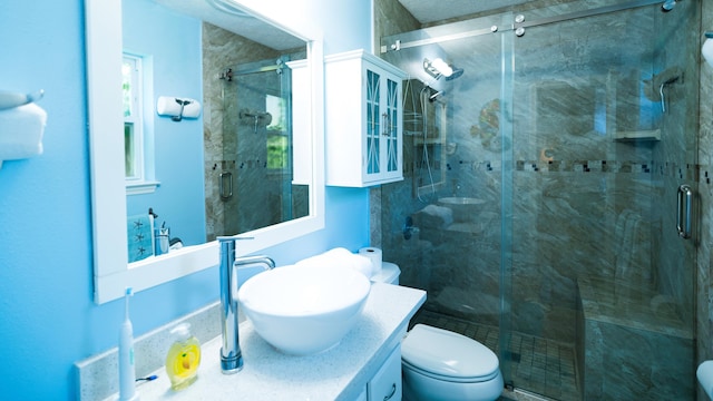 bathroom with vanity, toilet, and walk in shower