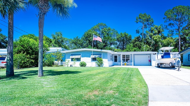 ranch-style home with a garage and a front yard