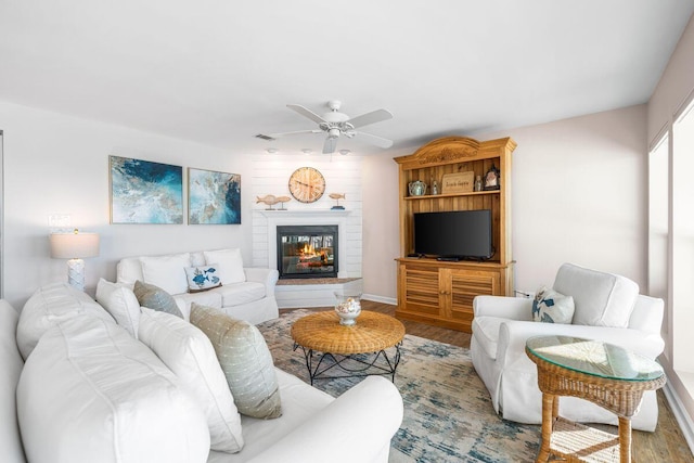 living room featuring wood-type flooring and ceiling fan