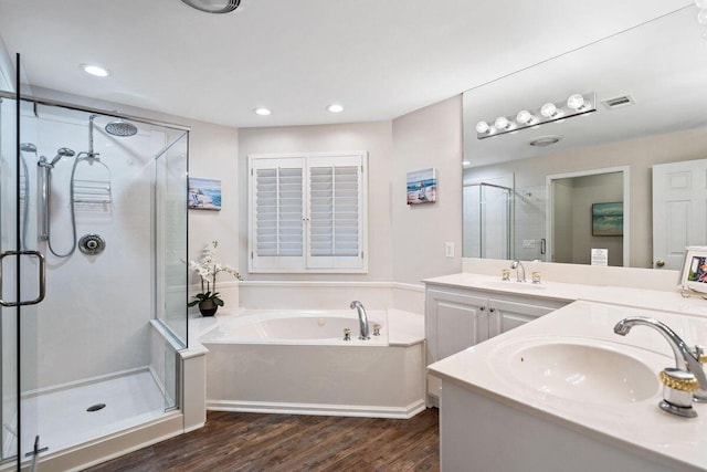 bathroom featuring hardwood / wood-style flooring, vanity, and independent shower and bath