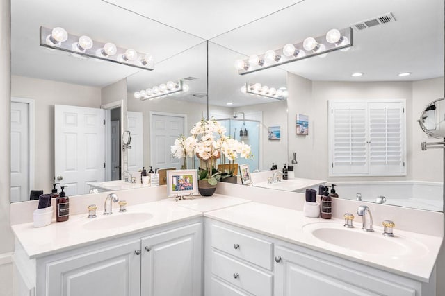 bathroom featuring walk in shower and vanity