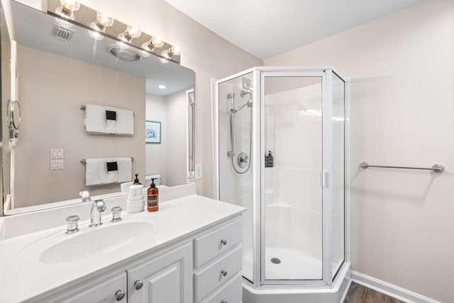 bathroom featuring vanity and an enclosed shower