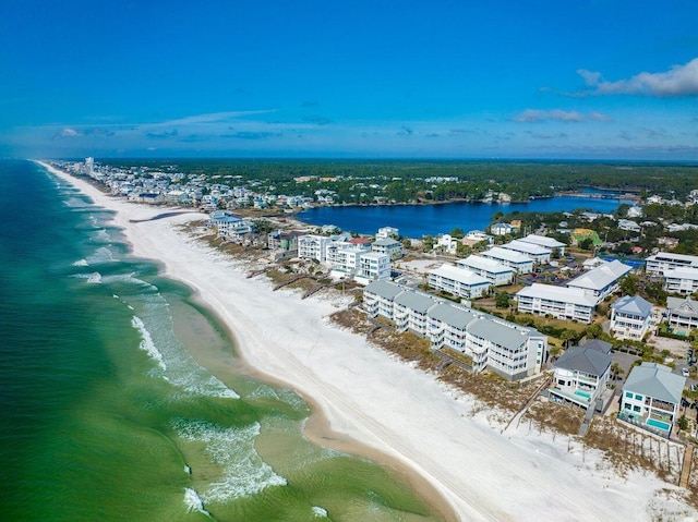 drone / aerial view featuring a water view and a beach view