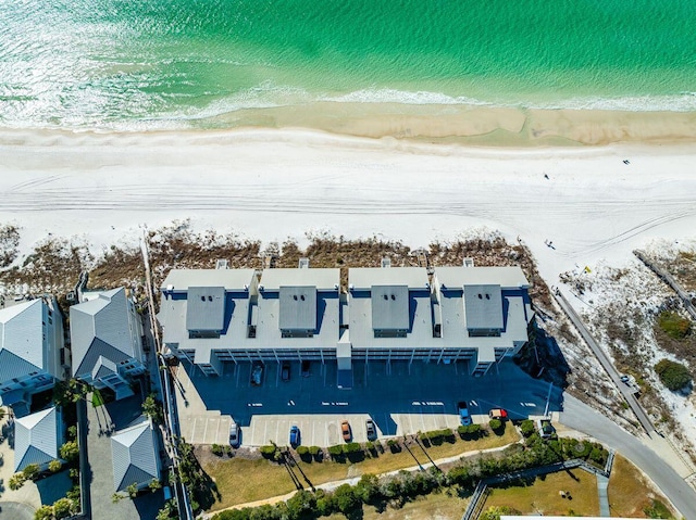 birds eye view of property featuring a water view and a beach view