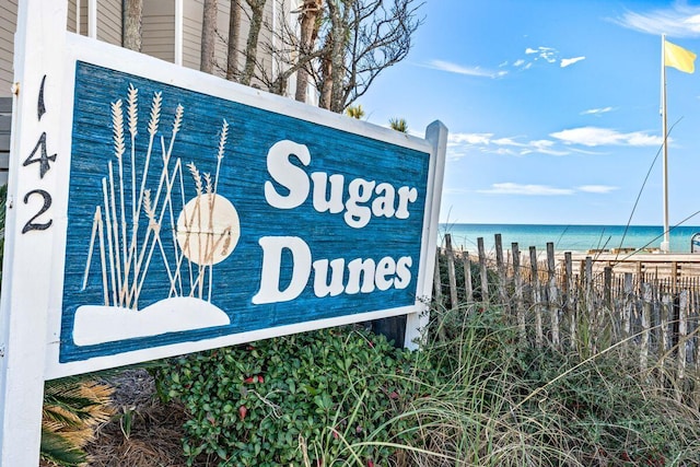 community sign with a water view