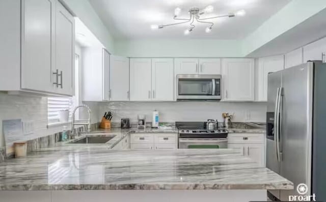 kitchen featuring white cabinets, stainless steel appliances, and sink