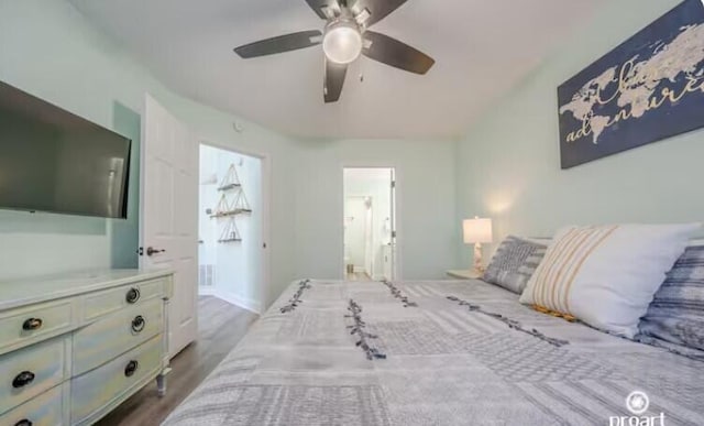 bedroom featuring hardwood / wood-style floors, ensuite bath, and ceiling fan