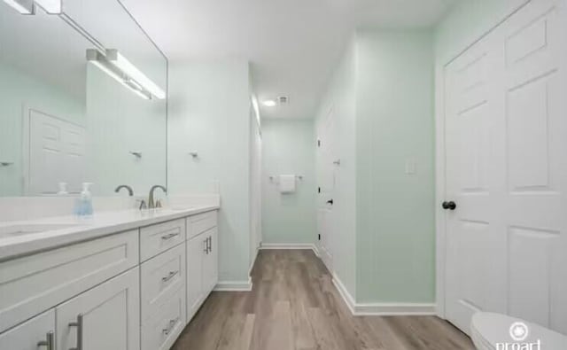 bathroom featuring vanity and hardwood / wood-style flooring