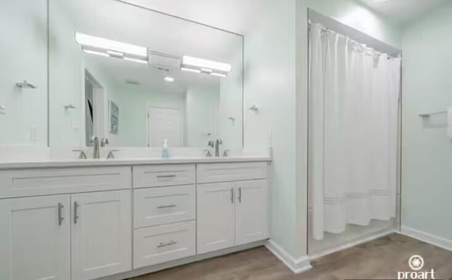 bathroom with hardwood / wood-style floors, vanity, and shower / bath combination with curtain