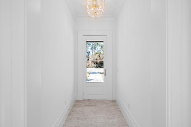 doorway to outside with crown molding, light hardwood / wood-style flooring, and a notable chandelier