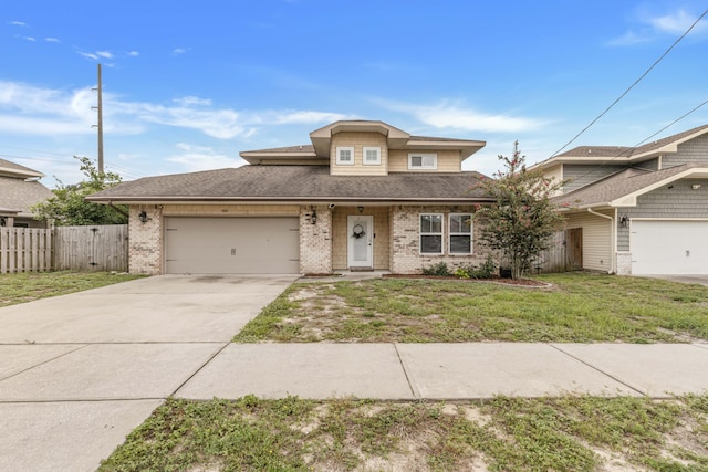 view of front of property featuring a garage and a front lawn