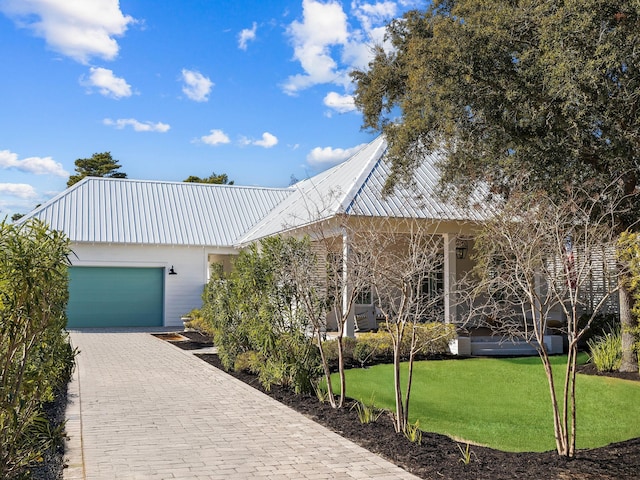 view of front of property with a garage and a front yard