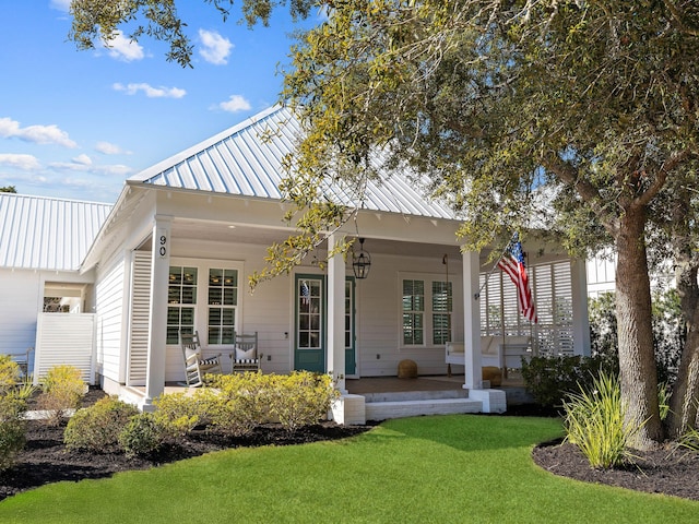 back of house featuring a porch and a yard