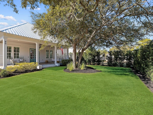 view of yard featuring covered porch