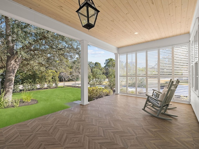 unfurnished sunroom with wood ceiling