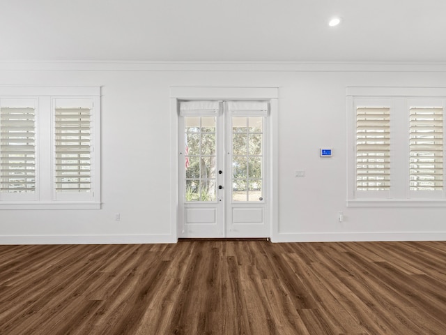 entrance foyer with french doors, dark hardwood / wood-style flooring, and crown molding