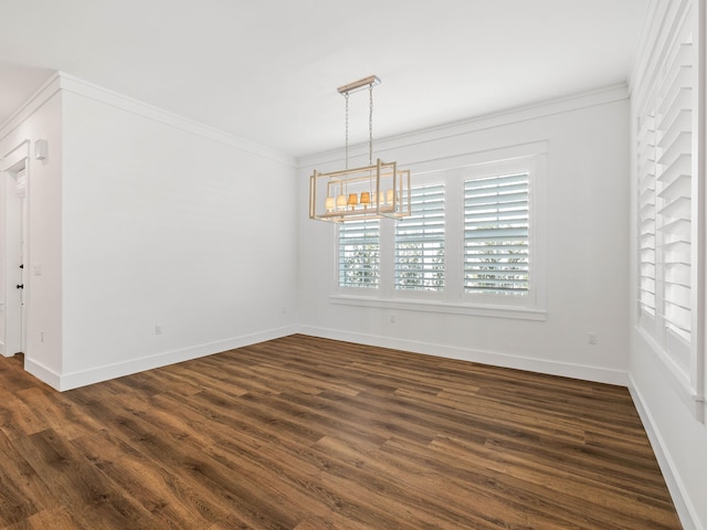 unfurnished dining area with dark hardwood / wood-style flooring, ornamental molding, and an inviting chandelier