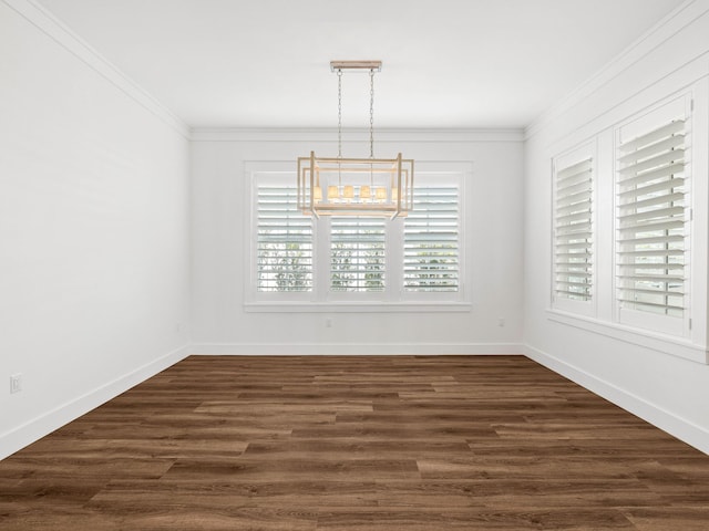 unfurnished dining area featuring an inviting chandelier, ornamental molding, and dark hardwood / wood-style floors